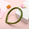 Handmade green plush headband accessory for women on a pink decorative background - Green