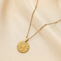 Detail of gold Gemini constellation embossed coin pendant on beaded necklace - Gemini
