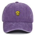 Close-up of purple washed cotton baseball cap featuring yellow melting smiley face embroidery - Adjustable / Purple