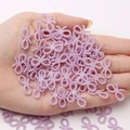 Handheld view of purple pearl finish bow-shaped beads for DIY jewelry making accessories - Light Purple