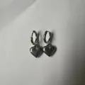Detailed view of silver stainless steel heart drop hoop earrings on grey background - Small Solid Heart / Silver