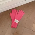 Pink wool knit long gloves with ribbed texture and vintage logo patch on wooden floor - One Size / Pink