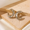 Close-up of polished silver geometric C-shape hoop earrings on a marble surface - C-Shape Smooth Thickened Stud Earrings Silver (F602)