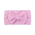 Soft pink nylon baby headband featuring a large bow design and stretchy fabric - Flesh Pink