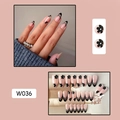 Macro detail of almond shaped press-on nails with nude pink base and black floral French tips - W036 Black Small Flowers