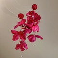 Detail view of red silk flower tassel earrings with golden chains and crystal drops - Magenta Glossy Bead Style