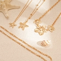 Goldenes Seestern und Blumen Halsketten-Set mit vier minimalistischen Ketten im Meeresstil - Gold Seestern Blume Kombination Set