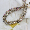 Macro shot of 6mm champagne faceted crystal glass beads with iridescent rainbow finish - 6mm (approx. 100pcs) / Purple Fuchsia
