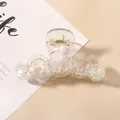 Macro detail of aurora gradient transparent hair claw clip with golden metal spring - Transparent AB Five Circles Hair Claw