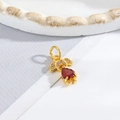 Close-up of golden girl pendant featuring a large red teardrop zircon and small white stones - Little Girl - Red Heart