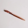 Detail of rose gold metal ballpoint pen featuring crushed red stone crystal filler - Red Agate