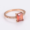 Macro detail of rose gold ring with rectangle orange zircon and side pavé diamonds - US 7 / Rose Gold Color / Red Zirconia