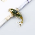 Green crystal gravel and gold foil koi fish resin ornament on a white desk - Aventurine Jade