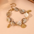 Detailed view of the gold sea-themed charms and natural shell beads of the summer bracelet - Shell Beaded Bracelet