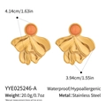 Macro detail of French vintage geometric earrings with gold texture and coral stones - Coral Orange Style (YYE025246-A)