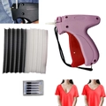 Macro detail of the quick clothing fixer gun kit including needles and fasteners - Pink