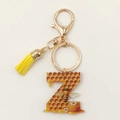 Detail of letter Z keychain with honeycomb pattern, yellow tassel and golden lobster clasp - Letter Z