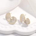 Detailed macro shot of golden spiral shell earrings with textured finish on a ceramic plate - Style A / 1 Pair / Silver