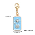 Detail view of a light blue enamel tarot charm with sun motif and gold finish - Blue Starry Enamel Pendant