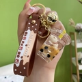 Brown acrylic bubble tea keychain with cute bear floating in liquid and silicone strap - Milk Tea Cup + Silicone Strap Style