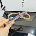 Dettaglio ravvicinato di un fermaglio per capelli con fiocco in strass arcobaleno - Stile Strass Colorato Chiaro