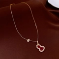 Detail of gold gourd pendant necklace with red inlay and diamonds on brown silk - Red & Gold Gourd (WN3)