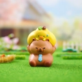 Cute brown bear figurine with yellow chick topper and blue tie on green grass - 3087 Capybara with Pear