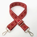 Detail of red woven bag strap with adjustable golden hardware on white background - Burgundy