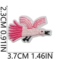 Macro detail of bird embroidery patch in pink with dimensions 2.3x3.7cm on white background - No.9 Pink Bird