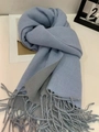 Detail of blue and grey cashmere-like scarf with fringe on white surface - Gray Blue