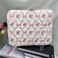 Close-up of quilted floral tablet sleeve with pink roses, bow prints and dual metal zippers - 11" / Pink Rose
