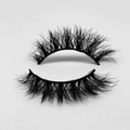 Close-up of short black 3D faux mink eyelashes with dense curls on white background - D71S