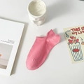 Single pink low cut cotton blend sock with heel tab on a minimalist white table - One Size / Rose Red