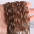 Strands of 2mm dark brown agate round stone beads with a polished glossy finish - Smoky Quartz