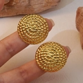 Elegant gold round hoop earrings with spiral woven texture shown on a finger - Twisted Texture Round Disc (E0883)
