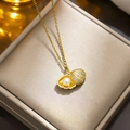 Elegant gold plated shell pendant necklace featuring a pearl and pavé crystals detail - 8834 Golden Shell