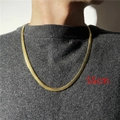 Detail shot of a 55cm gold flat snake bone chain necklace worn by a model - Gold-55cm