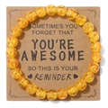 8mm translucent yellow stone bead bracelet on a brown cardboard reminder gift card - Amber