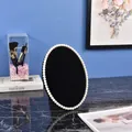 Oval jewelry display stand with pearl edge and black velvet surface for earrings - Medium / Black