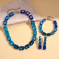 Close-up of geometric square blue crystal jewelry set with necklace, bracelet, and earrings - Necklace Earrings Bracelet 3-Piece Set / Gradient Blue