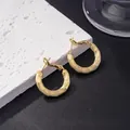 Elegant gold-plated textured hoop earrings with vertical stripes on a marble display - Thread Texture Hoop / E-081---Gold
