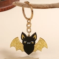 Gouden sleutelhanger met zwarte vleermuis hanger van acryl en glimmende vleugels - Zwarte Vleermuis Acryl Hanger