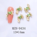 Nail art decoration featuring a golden 3D bow with a green heart-shaped zircon gem - Gold Bowknot Green Heart(9434)