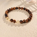 Macro detail of tiger eye stone beads and gold metal accents on a beaded bracelet - 6# Tiger Eye and Citrine Beaded Bracelet