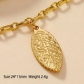 Detail view of a gold leaf pendant with realistic texture, size 24x13mm and weight 2.4g - Textured Leaf-26