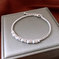 Detailed macro view of zircon and pearl chain bracelet with adjustable clasp closure - Silver