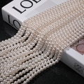 Macro detail of high-luster white round pearls strands with smooth texture and strong shine - 3mm (Approx. 240pcs/Strand) / 650 (No. 6)