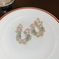 C-shaped golden earrings with multi-color gemstones and pavé crystals on a plate - Style 1 Multi-Color Gemstone Silver Pin Zircon U-Shape Earrings (HE10375)