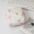Detailed view of quilted cotton cosmetic bag featuring pink bow patterns and zipper - White Base Pink Bow