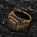 Macro shot of hip-hop men's ring with black micro-diamonds on gold band and rock background - US-7 / Gold-Black Zircon